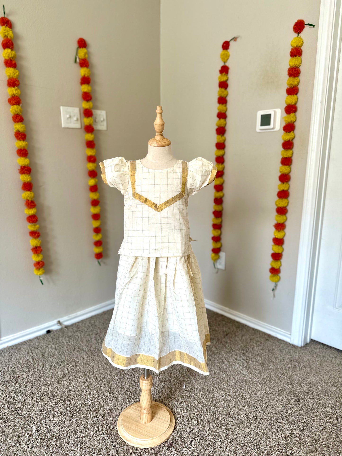 Half white checkered Kerala style kids lehenga