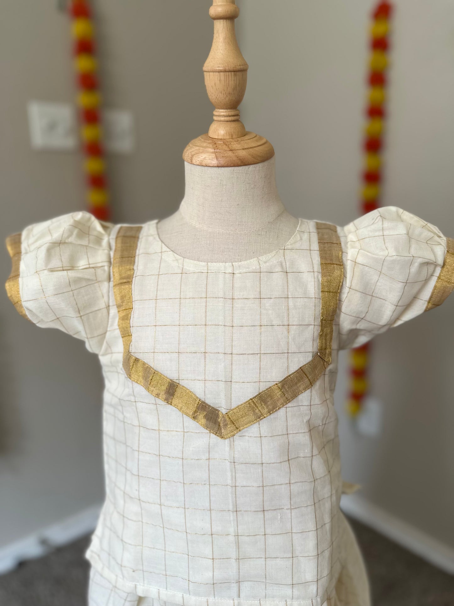 Half white checkered Kerala style kids lehenga